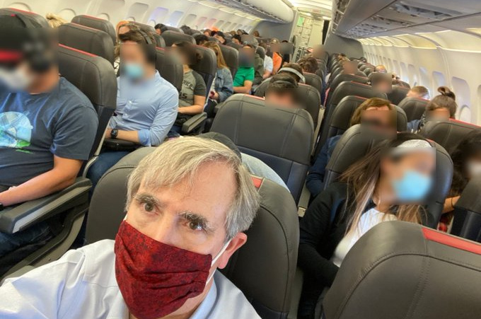 Senator-Jeff-Merkley-packed-plane.jpg